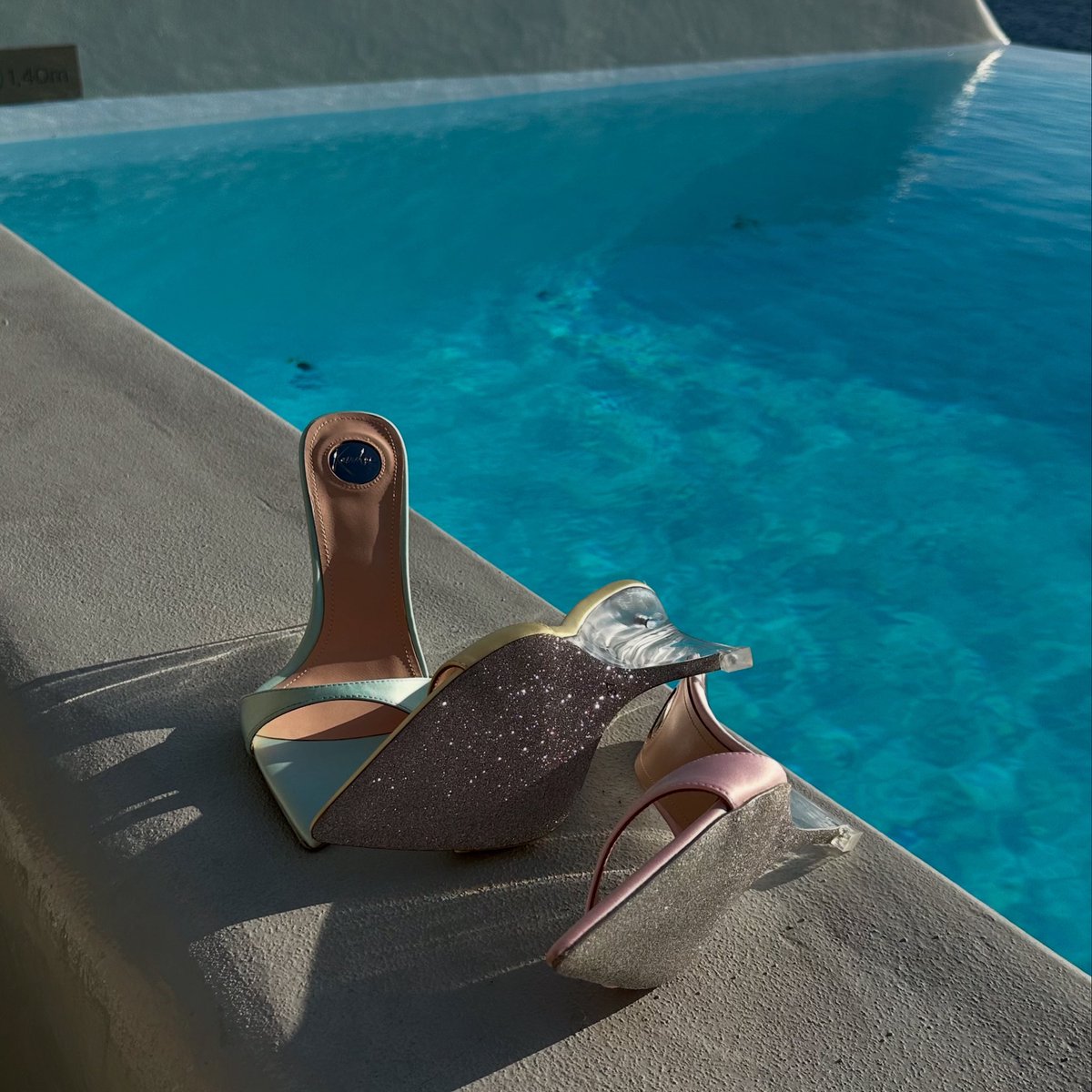Shimmering pastels, glittering heels, and the endless blue of Mykonos. 🌊✨ A touch of elegance where silk meets sparkle — made for golden hours like this. 💎👠☀️ Kandee.co.uk

#LuxuryStyle #MykonosVibes #ChicEscape #ResortGlam #AegeanDreams #LuxuryFootwear
