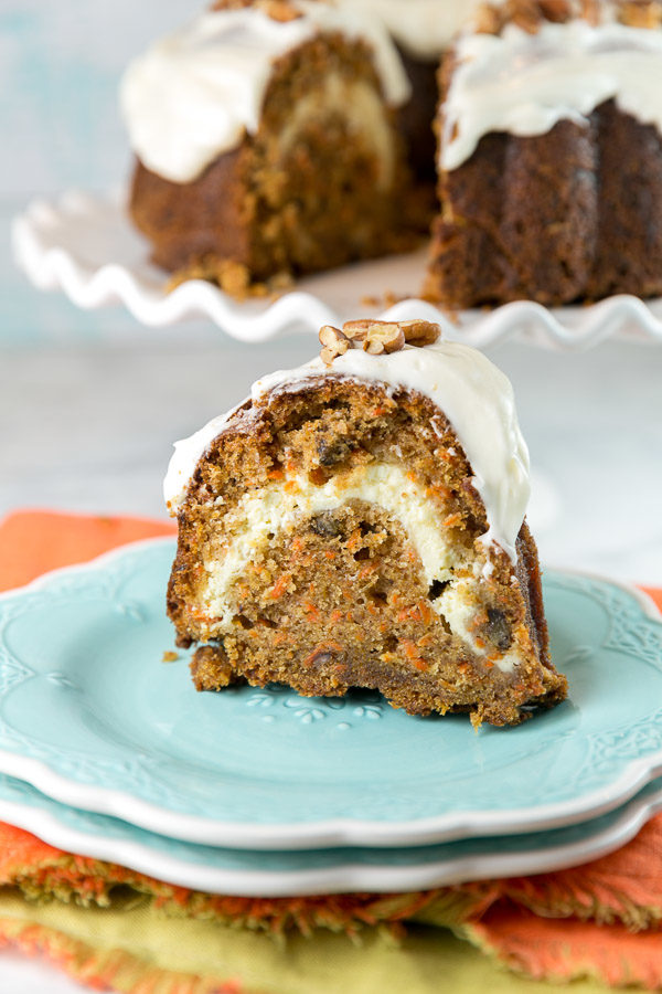 Love carrot cake but don't want to bake and frost a layer cake? This Carrot Bundt Cake with a cream cheese swirl and cream cheese frosting is the answer! bunsenburnerbakery.com/carrot-bundt-c…