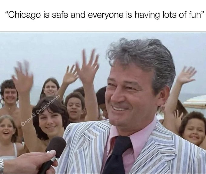 A man in a striped suit and pink tie holding a microphone, smiling broadly, with raised hands and people in the background, some appearing happy. The text overlay reads "Chicago is safe and everyone is having lots of fun." A watermark "Oppa111 Memes" is visible.