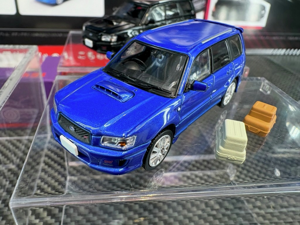 joshin_skl's tweet image. ホビージャパンが展開する新ブランド「 MODEL MODEL」から １２月頃発売予定の1/64 スバル フォレスター SG9 Stiのサンプルが届きました！開閉可能なトランクと小物が付属、ホイールもStiバージョンとなっています。その他にも多数の発売前の新製品を展示しておりますので、ぜひ間近でご覧ください！