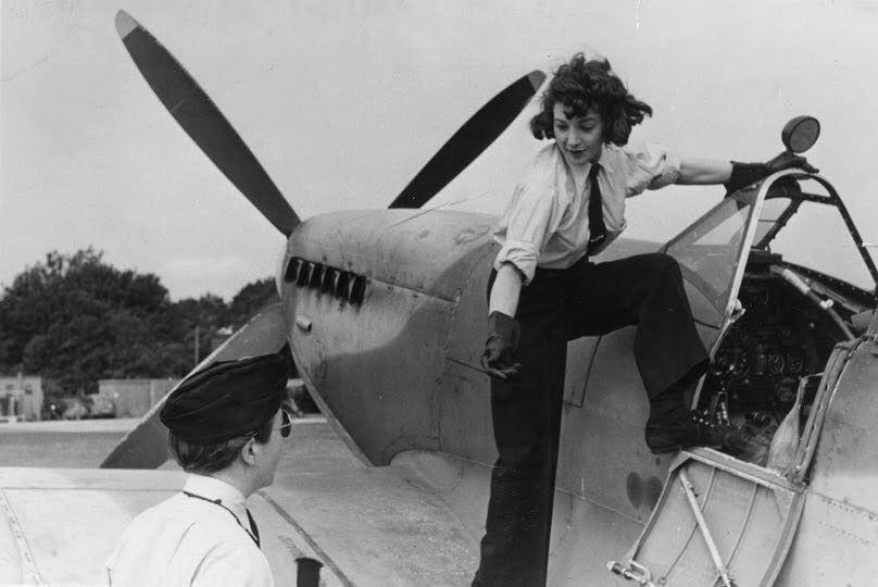 South African, Jackie Moggridge (1922-2004), a pilot of the Air Transport Auxiliary, climbs into the cockpit of a Spitfire fighter, September 1944.