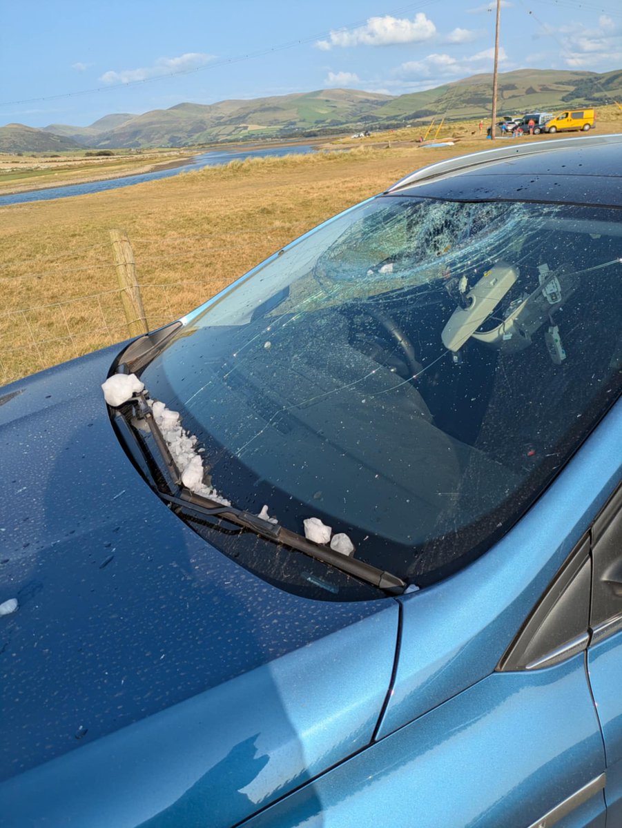 My daughter at the beach in Tywyn. Ball of Ice dropped out of the sky!! Nice new car inop. Insurers hopeless! Great holiday only just started.