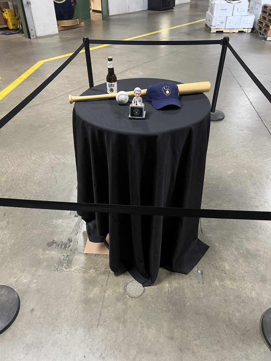 SWatsonTV's tweet photo. Bob Uecker parked his corvette just a bit inside the ballpark every game he worked. Today, his spot is saved with a Miller Lite, bobble head, Brewers hat, ball and bat. https://t.co/ujixcnZJn3