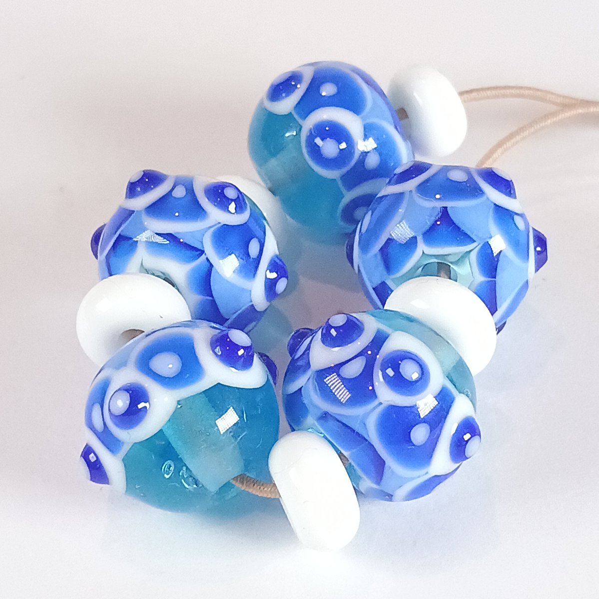 Beautiful one a kind handmade glass beads - pale blue with a dragonscale pattern layers of white and cobalt blue dots - jolene-beads.myshopify.com/products/pale-… New to my website tonight #lampwork #glassbeads #jewellerydesign #handmadecreations