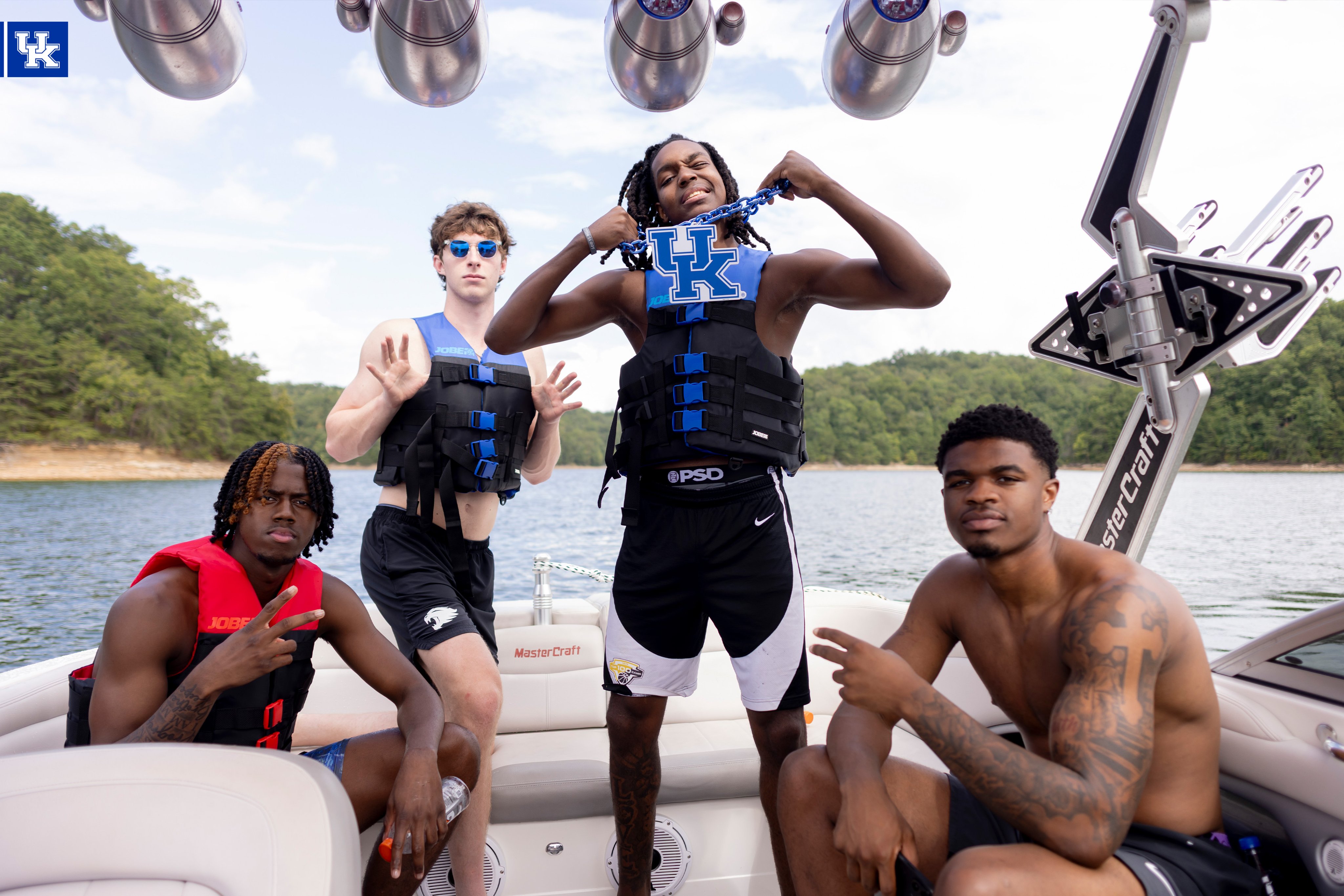 Kam Williams, Reece Potter, Jasper Johnson, and Otega Oweh on a boat.