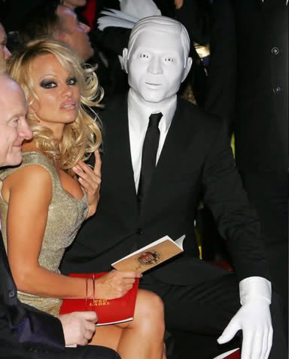 historyinmemes's tweet image. Pamela Anderson appeared at a 2008 London fashion show alongside a mysterious masked companion, rumored by many to be Michael Jackson in disguise.
