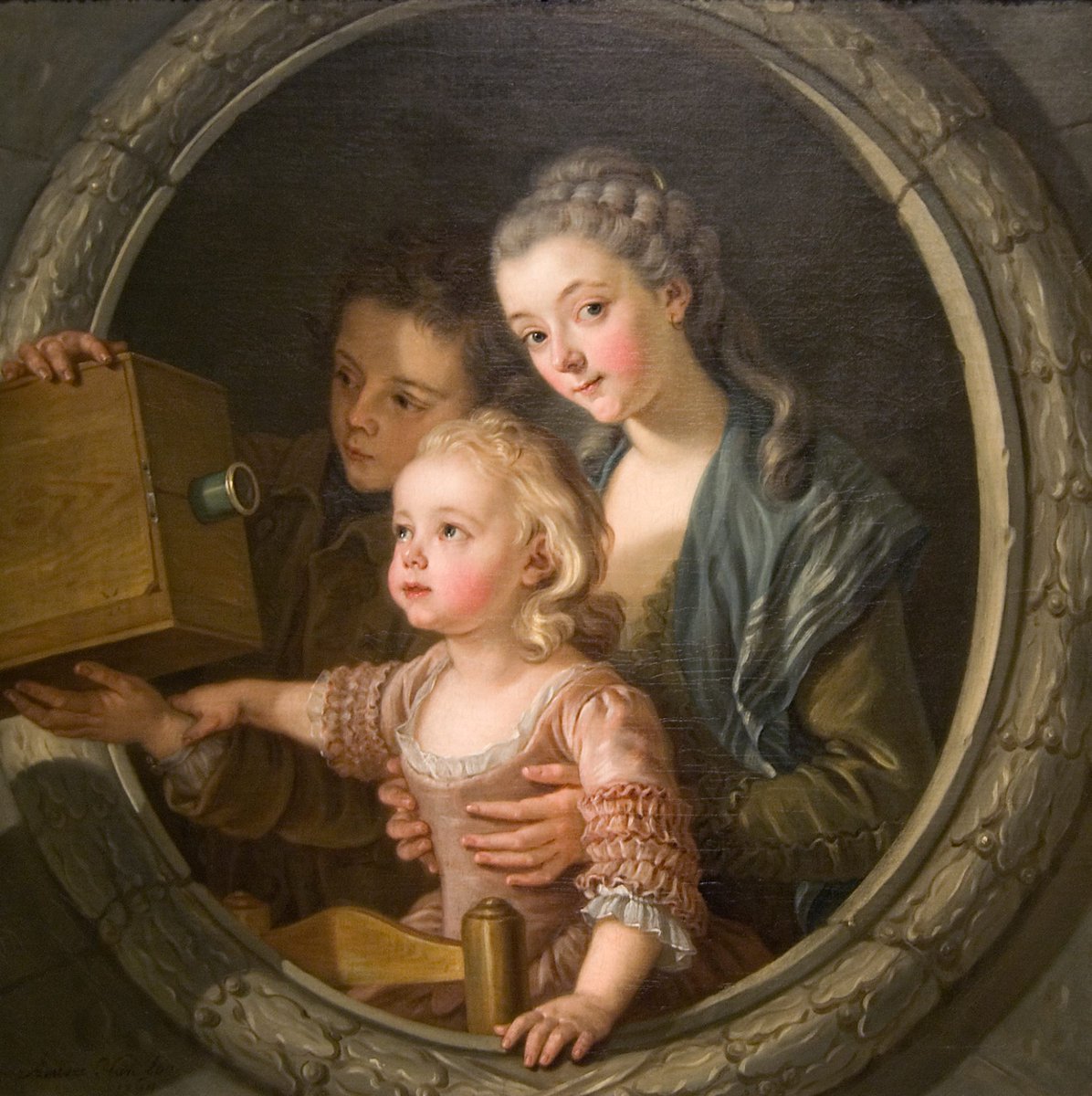 Camera Obscura (1764), one of those wonderful instances of an artist using the frame to enhance the realism of his subject by causing it to burst out into the spectator's world. By Charles Amédée Philippe Van Loo who worked for members of the Prussian Imperial family.