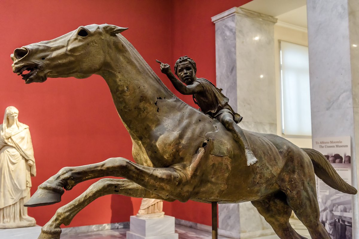 Bronze statue of horse and young jockey in National Archaeological Museum of Athens, Greece.