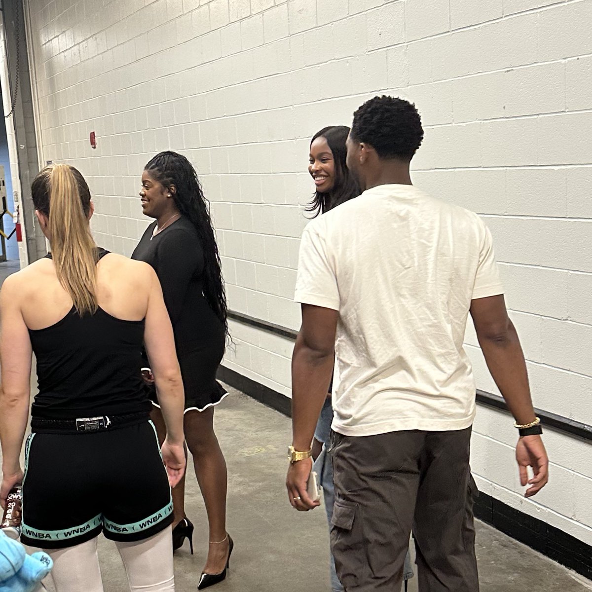 Sabrina Ionescu chatting it up with Coco Jones and Donovan Mitchell after the game.