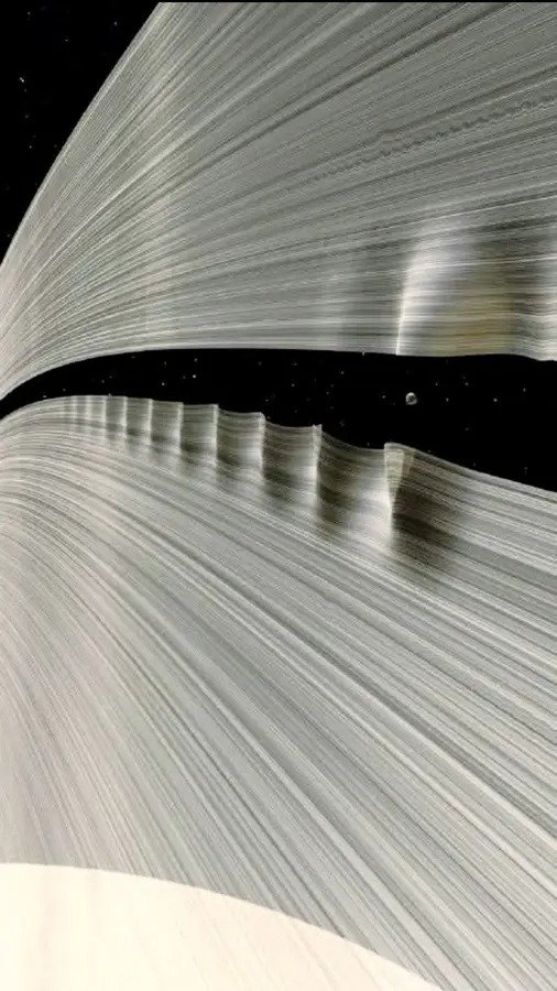 A Tiny Moon Creating Giant Waves in Saturn's Rings  [Render by Kevin M. Gill]