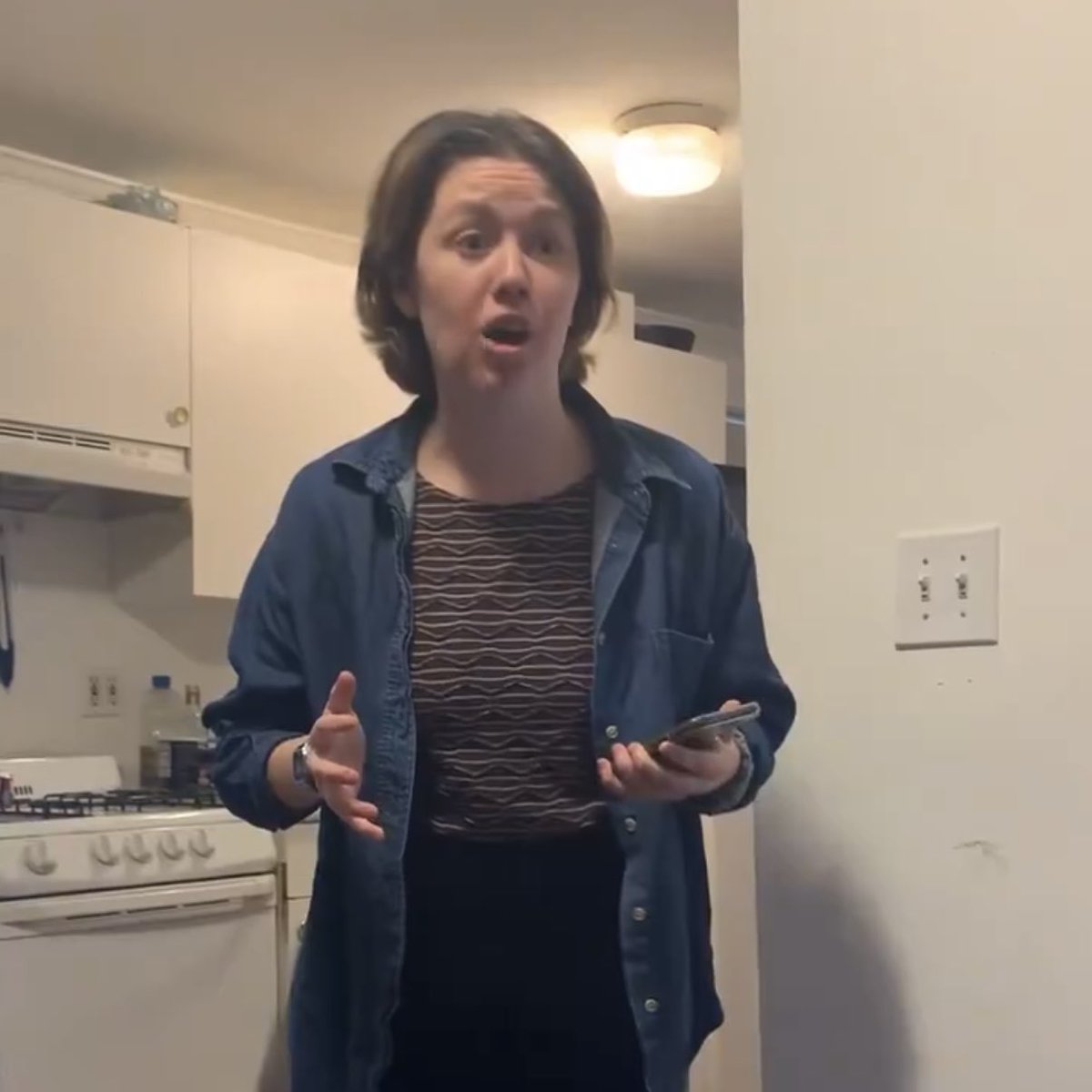 She’s wearing vertical stripe, like prisoners in the olden days. Also vertical stripes look like prison bars. Plus, she’s surrounded by pink flowers, which are a symbol for vaginas. She’s clearly once again sending out a signal that she is a lesbian and feels imprisoned by him