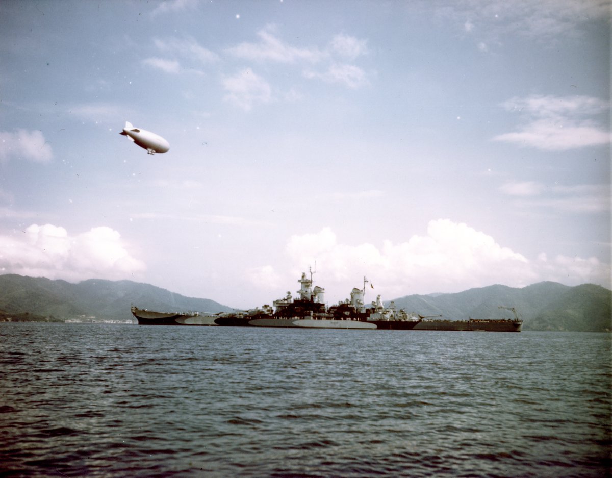 USS Missouri resting at anchor in the Gulf of Paria off Port of Spain, Trinidad during her shakedown cruise, Aug 26, 1944. Note K-class airship overhead.