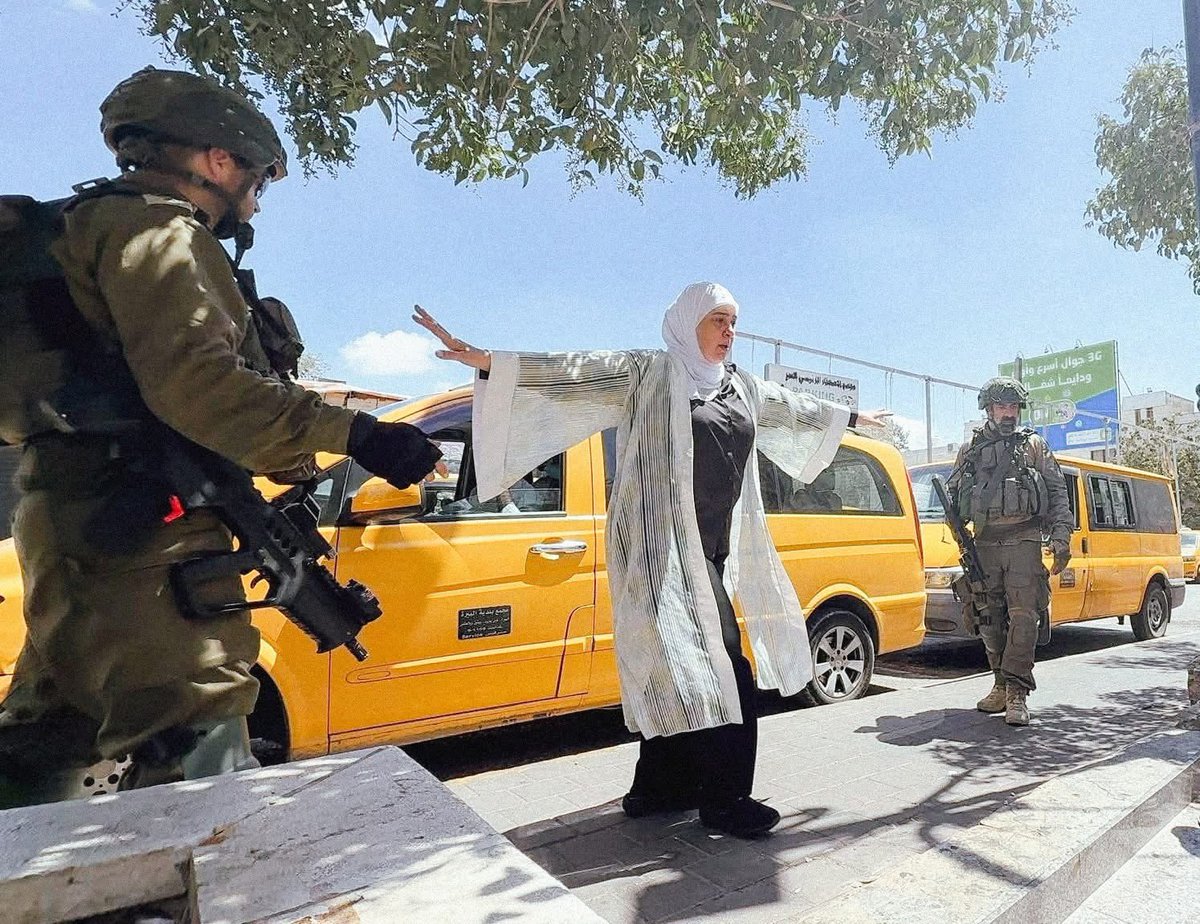 Iconic picture of Dr. Laila Ghannam, the Governor of Ramallah, facing off Israeli soldiers during their raid of her city this Tuesday. 58 residents were injured during the Israeli assault, including a child.