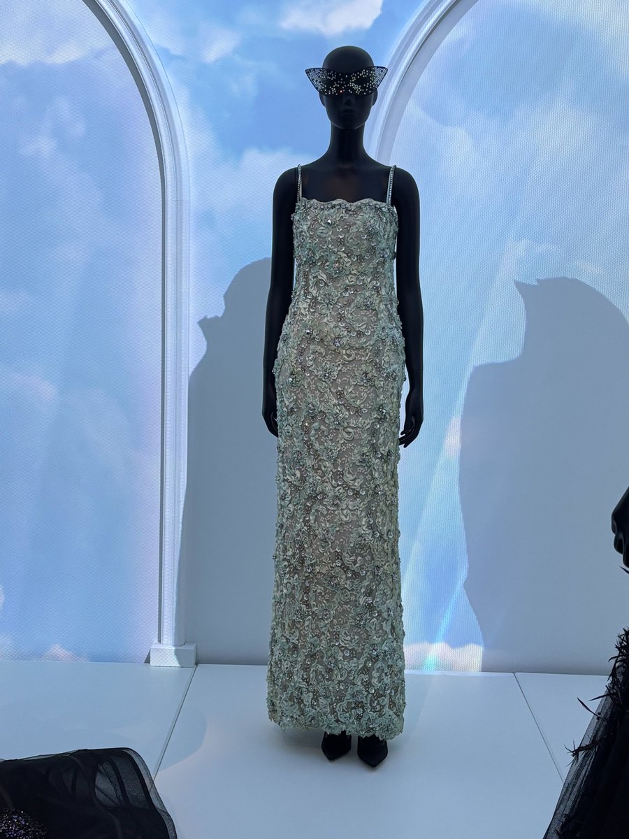 It is unfortunate that this dress was in the back of The Dior Ball in #legaleriadior, because the details are incredible! It's a 1965 Dior gown by Marc Bohan. It features a lace overlay adorned with ruched ribbons, sequinned flowers, and silver beads and rhinestones. The close