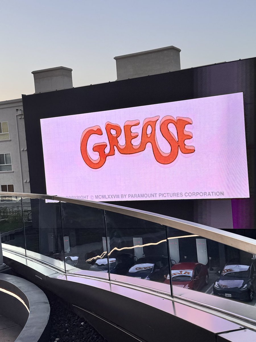 babudayyeh's tweet image. ⁦@Tesla⁩ diner enjoying a burger with robots and watching Grease outdoors after work with my daughters! Super cool!