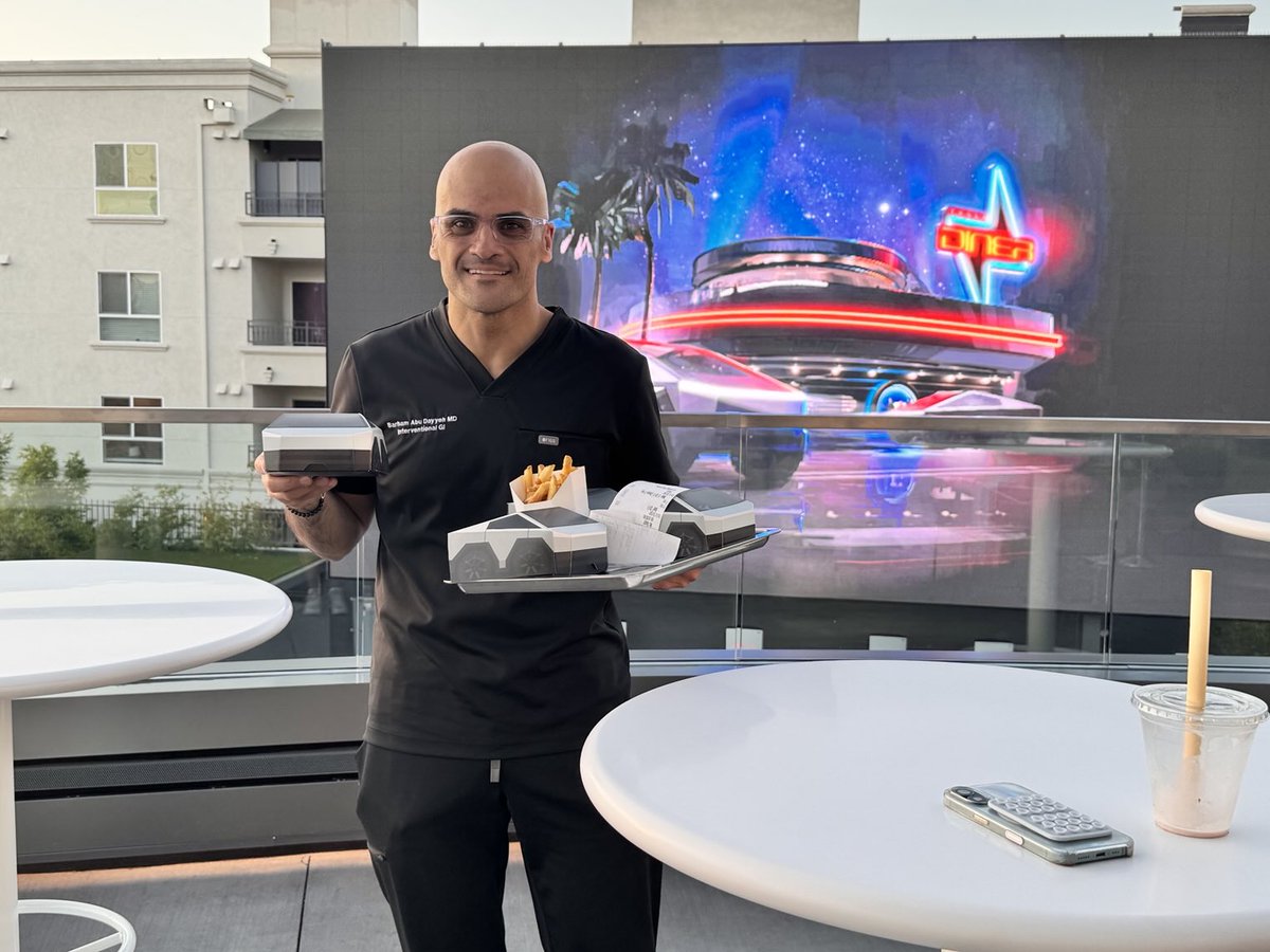 babudayyeh's tweet image. ⁦@Tesla⁩ diner enjoying a burger with robots and watching Grease outdoors after work with my daughters! Super cool!