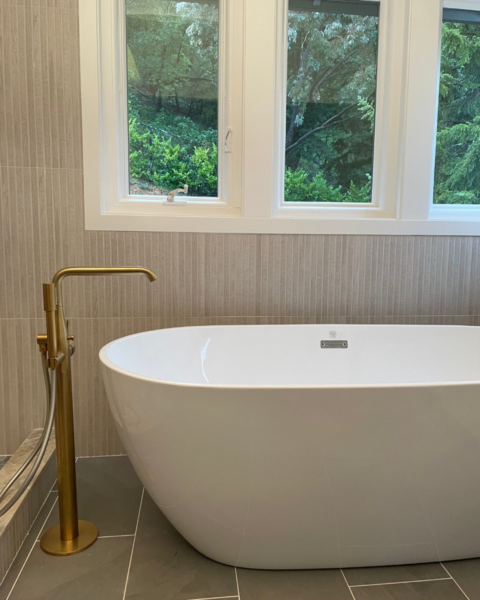 SPQconstruction's tweet photo. Luxury meets functionality in this bathroom remodel. Stunning white cabinetry, dramatic black countertops with warm brass accents, and a freestanding soaking tub ensure total relaxation. https://t.co/SgUorBtOLT