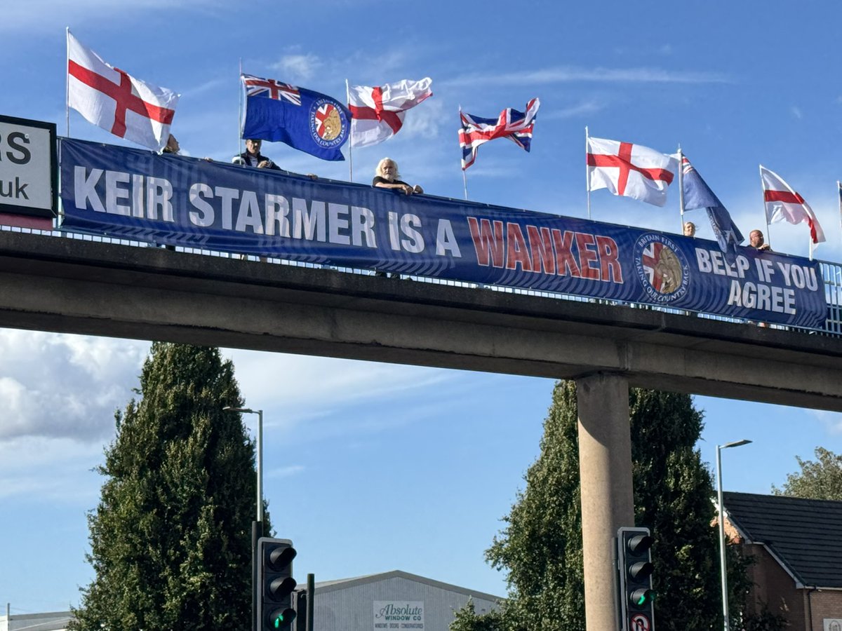Britain First activists unfurl a gigantic ‘KEIR STARMER IS A WANKER!’ banner over a bridge during rush hour in Manchester / Salford! #BritainFirst