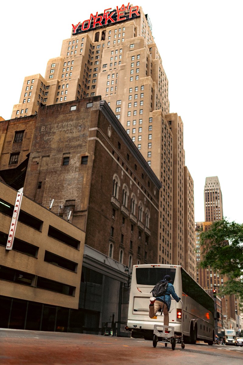Fresh from B&amp;H with a new drive, I wandered under the New Yorker sign. A guy flew past on a handtruck, kick-push…. red sneakers flashing. 

One frame, 
NYC: bold, unpredictable, fleeting.

sigue inventando
