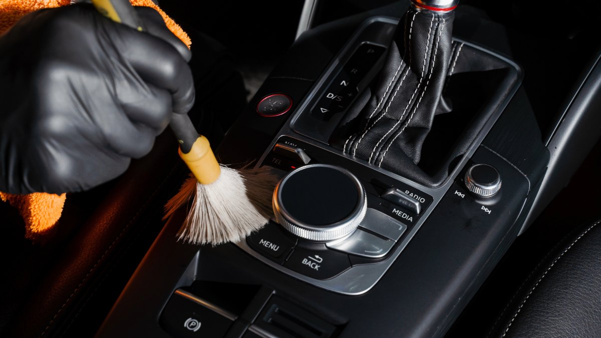Quick cleaning hack! ✨ Use a soft-bristle paintbrush to easily brush crumbs and dust out of hard-to-reach crevices &amp; cracks in your car's interior. A simple trick for a cleaner ride! #CarCleaningHack #CarCare #DetailingTips