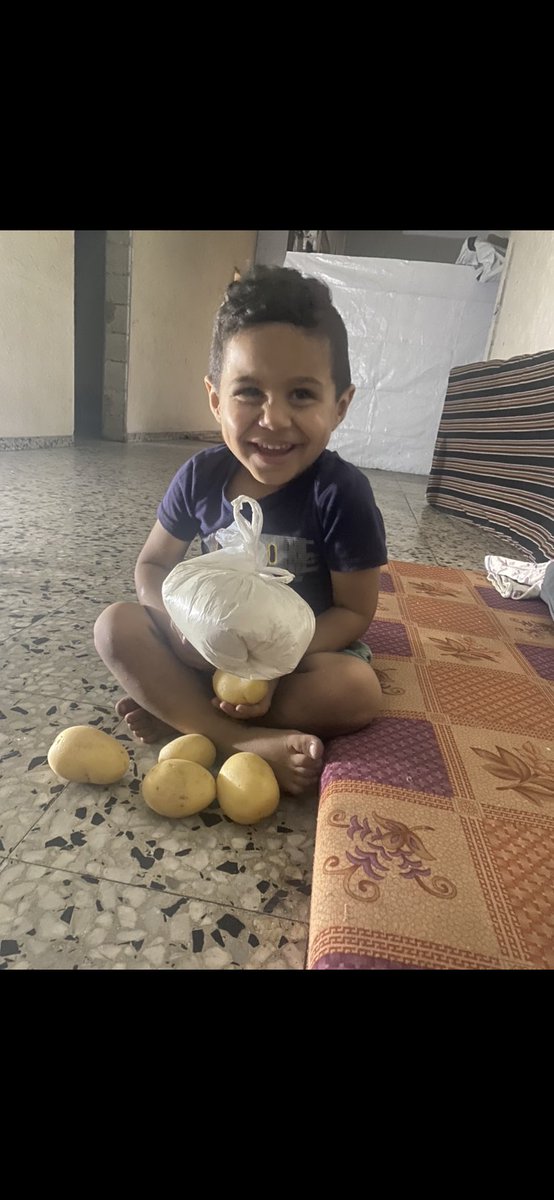 The joy on my child’s face over a bag of flour and a few potatoes…
It was as if I had given him a brand-new bicycle or a big toy he had always dreamed of.
But tell me, world, is this justice?

Today, after having just a little food, my son Adam kissed me and whispered:
“Thank