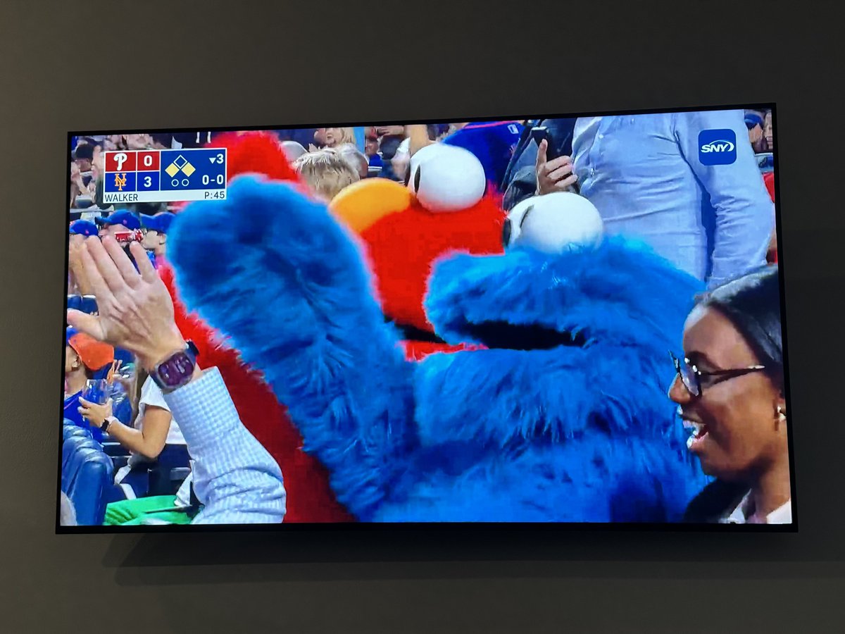 Les Mascots siting at the Mets v Phillies game