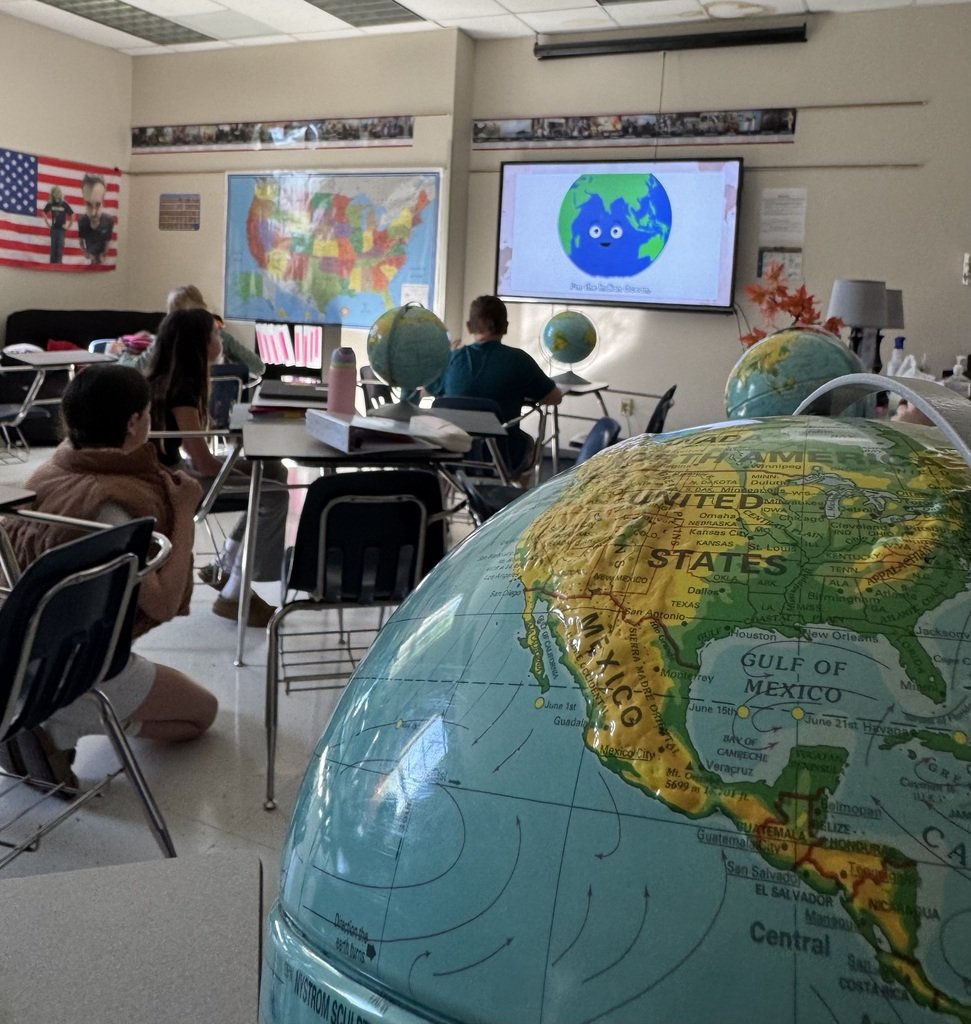 Our students have been "going places" studying U.S. geography.  Today, Mr. Reynolds's history classes were "on the ball" using globes and engaging in a sing-a-long.