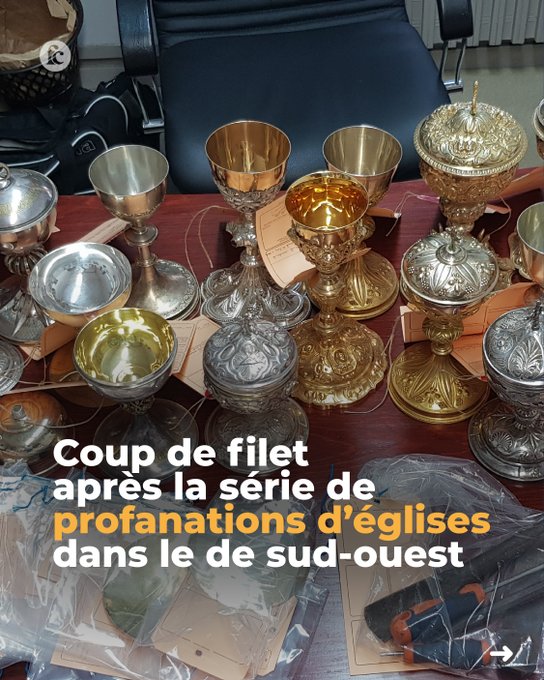 Multiple ornate chalices and religious items, including silver and gold cups with intricate designs, arranged on a wooden table. Plastic bags and papers are visible nearby. A watermark from X is present.