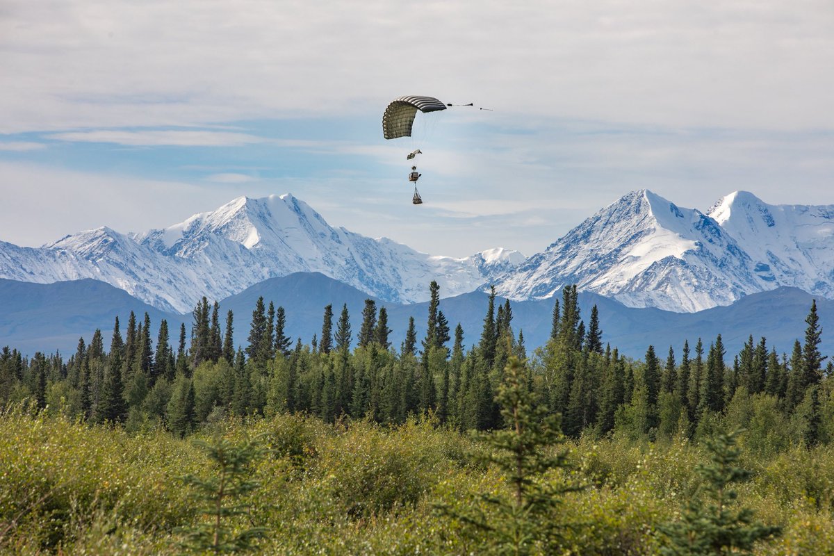 socnorth's tweet photo. International partners observe an experimental drop during Arctic Edge 25 near Tok, Alaska, Aug. 12, 2025. The experimental resupply system demonstrated how the military can sustain operations in environments where global positioning systems are denied or disrupted. https://t.co/6uq8bWkfCS