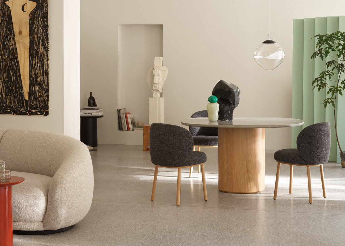 trithouse's tweet image. The Ovata Dining Table, featuring Grey Jura limestone and a black-stained oak base, seats up to six. Paired with the curved Ovata Dining Chair, the set blends sculptural design with comfort, ideal for home or hospitality, designed by @wendelbodk.