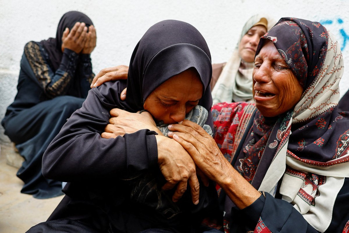 The mother of a Palestinian teenager killed by Israeli gunfire while waiting for aid in northern Gaza mourns at his funeral, holding his shoes.

🔴 LIVE updates: aje.io/4t3lil