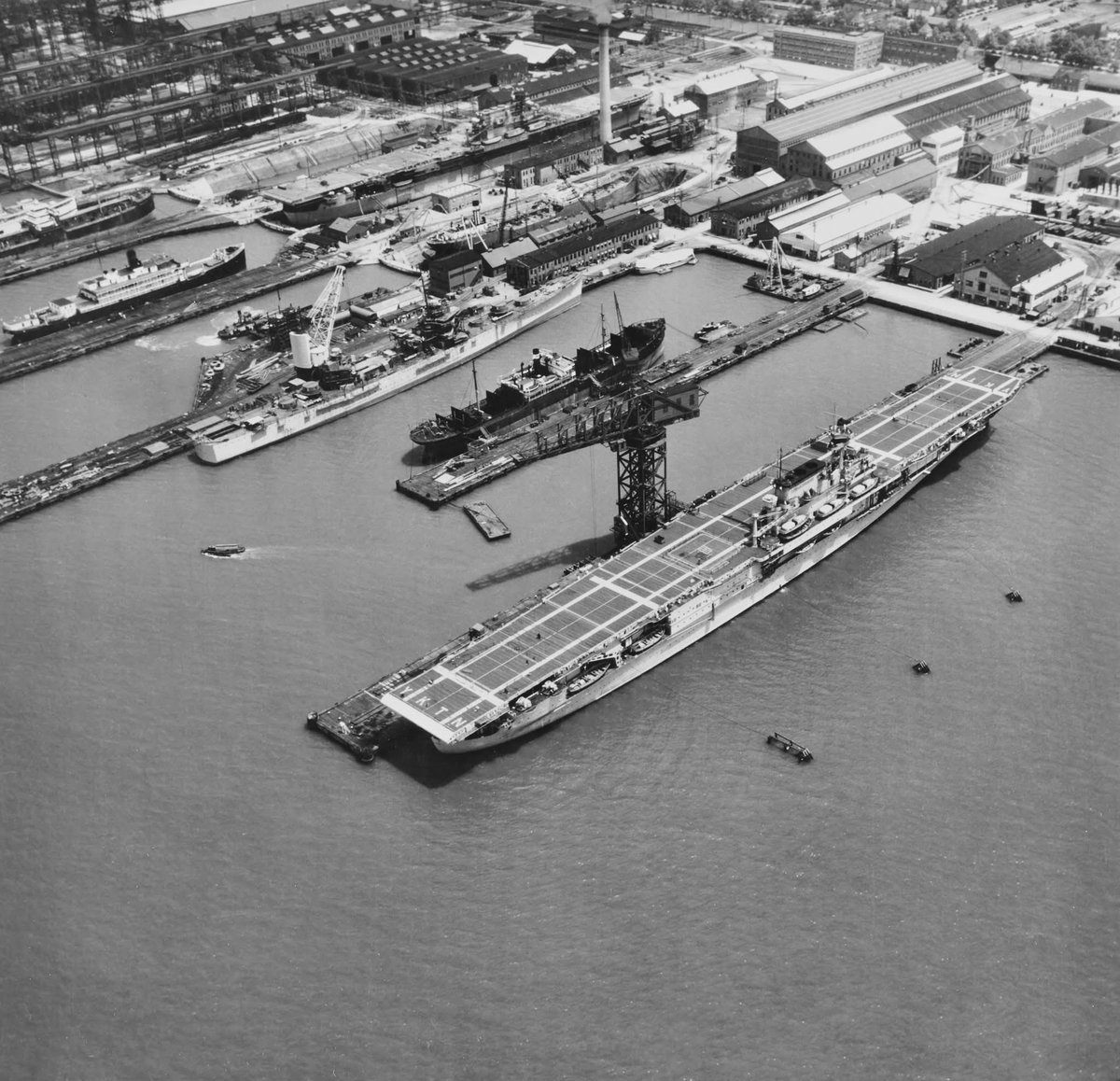 USS Yorktown pictured whilst preparing for sea trials in June 1937 at Newport News Shipbuilding &amp; Drydock Company Shipyard, USS Enterprise is fitting out in the Dry Dock in upper center, Brooklyn Class Light Cruiser USS Boise (CL-47) is two piers over from Yorktown, also fitting