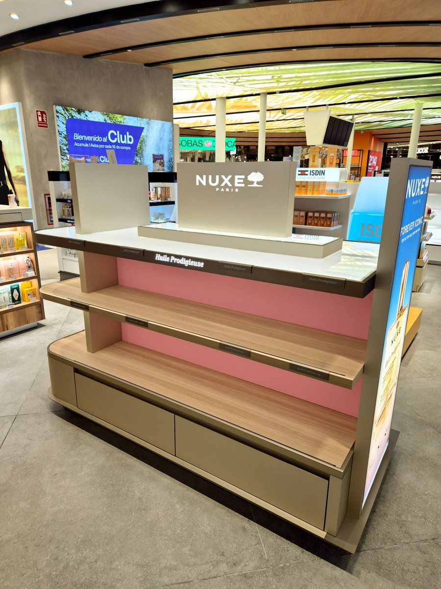 EBADER_GROUP's tweet photo. Stunning NUXE display gondola recently installed at Barcelona Airport. Designed and manufactured by EBADER, it stands out for its meticulous detailing and the use of wood-effect materials, achieving an aesthetically pleasing look without sacrificing functionality. https://t.co/G1bviLwfWU