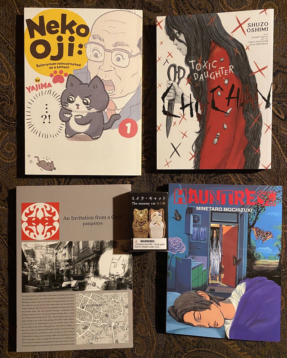 Here is the rest of the haul, from Kinokuniya…

“Neko Oji: Salaryman Reincarnated as a Kitten” by Yajima
“Toxic Daughter” by Shuzo Oshimi
“An Invitation From a Crab” by Panpanya
Minetaro Mochizuki’s “Hauntress”

And a small boxed mummy cat…