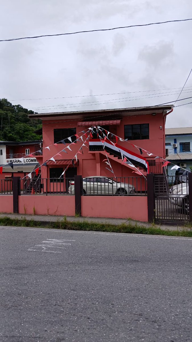 ImbertColm's tweet photo. Since the new Government has decided not to celebrate our country's Independence from the shackles of colonialism in 1962 and to cancel the traditional parade, and since they don't seem to like the colour red, I decided to decorate my constituency office in our national colours https://t.co/FyojGLUHqL