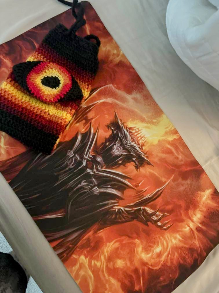 I started crocheting playmat tubes cuz I got bored. Ngl it's so nice to be able to shove it in my bag and not have to manage a tube + cap lol. I also made a little loop so they can just hang on. Made one for a friend who likes Magic to go with his playmat as well. #PlayPokemon