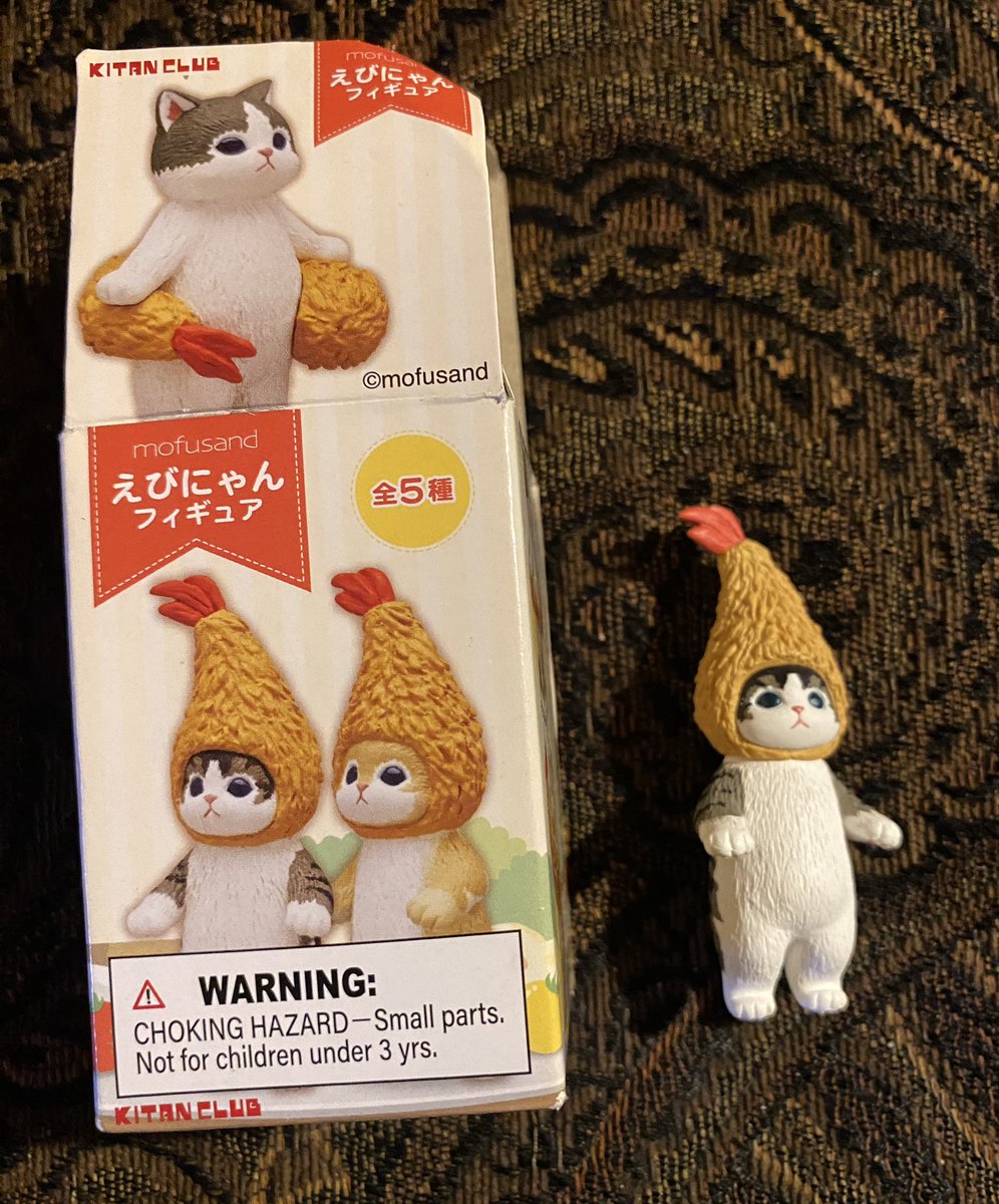 Last year, someone gave me this other cat figurine as a gift. 

It seems that it was made by the same company that manufactures the mummy cats, Kitan Club.

This cat pictured is wearing a fried prawn for a hat…