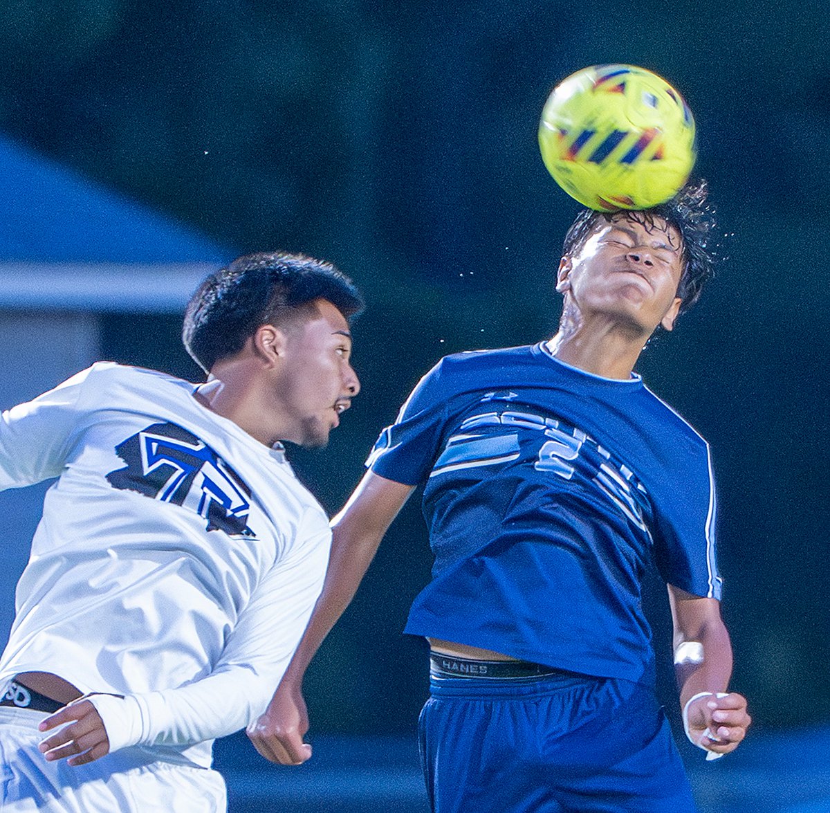South Brunswick’s Junior Ayala heads the soccer ball away from the Trask player.