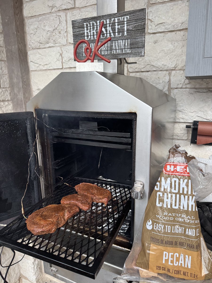 Aggiemundo's tweet image. I am currently “manning” my grill by smoking some steaks in pecan wood.  Normally I do cherry, but something about today just made slaughtered steer completely smoked with a nice nutty flavor to it sound good.  Some things in life are overrated, but I don’t think these will be.