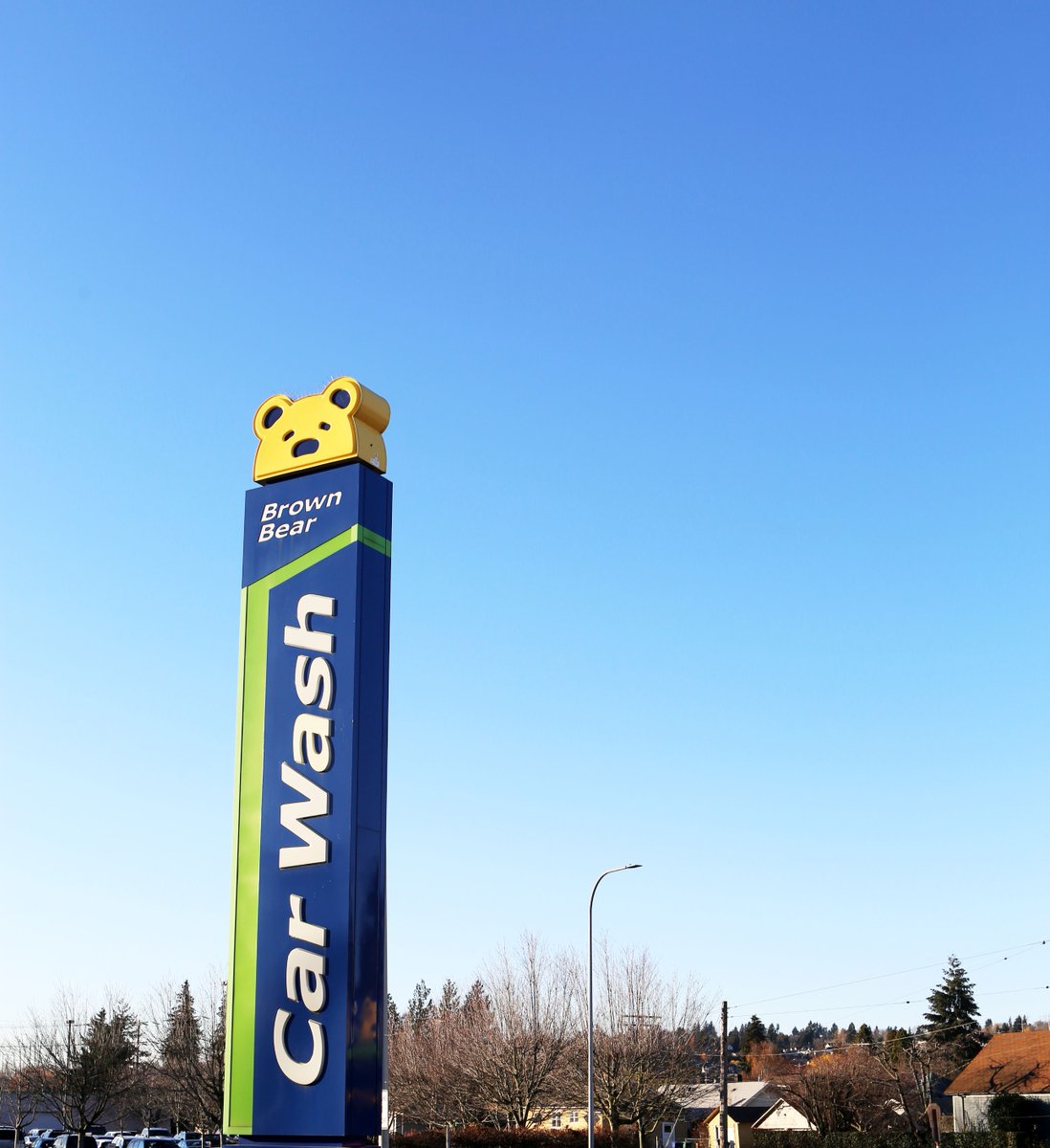 Spotted: A friendly bear waving you down for a wash! 👋🐻 Our iconic Brown Bear sign isn't just tall, it's a beacon guiding you toward a sparkling clean car.