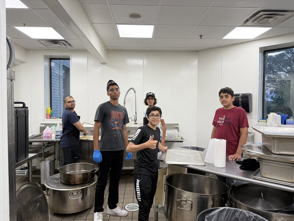 Khuddam, Atfal, and Ansar helping clean the mosque.