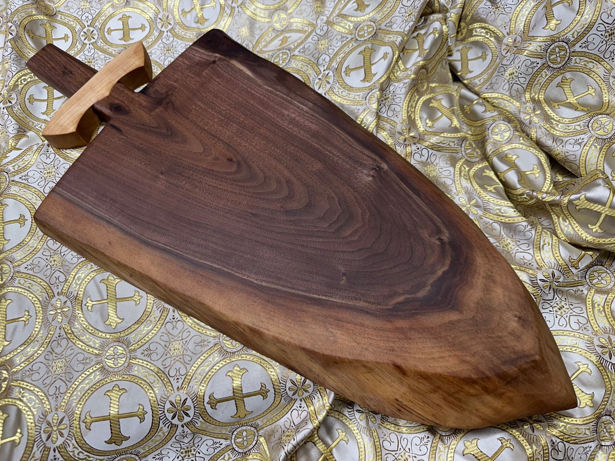 Two finished boards. One an end grain breadboard with custom handles, the other a live edge swordcuterie board