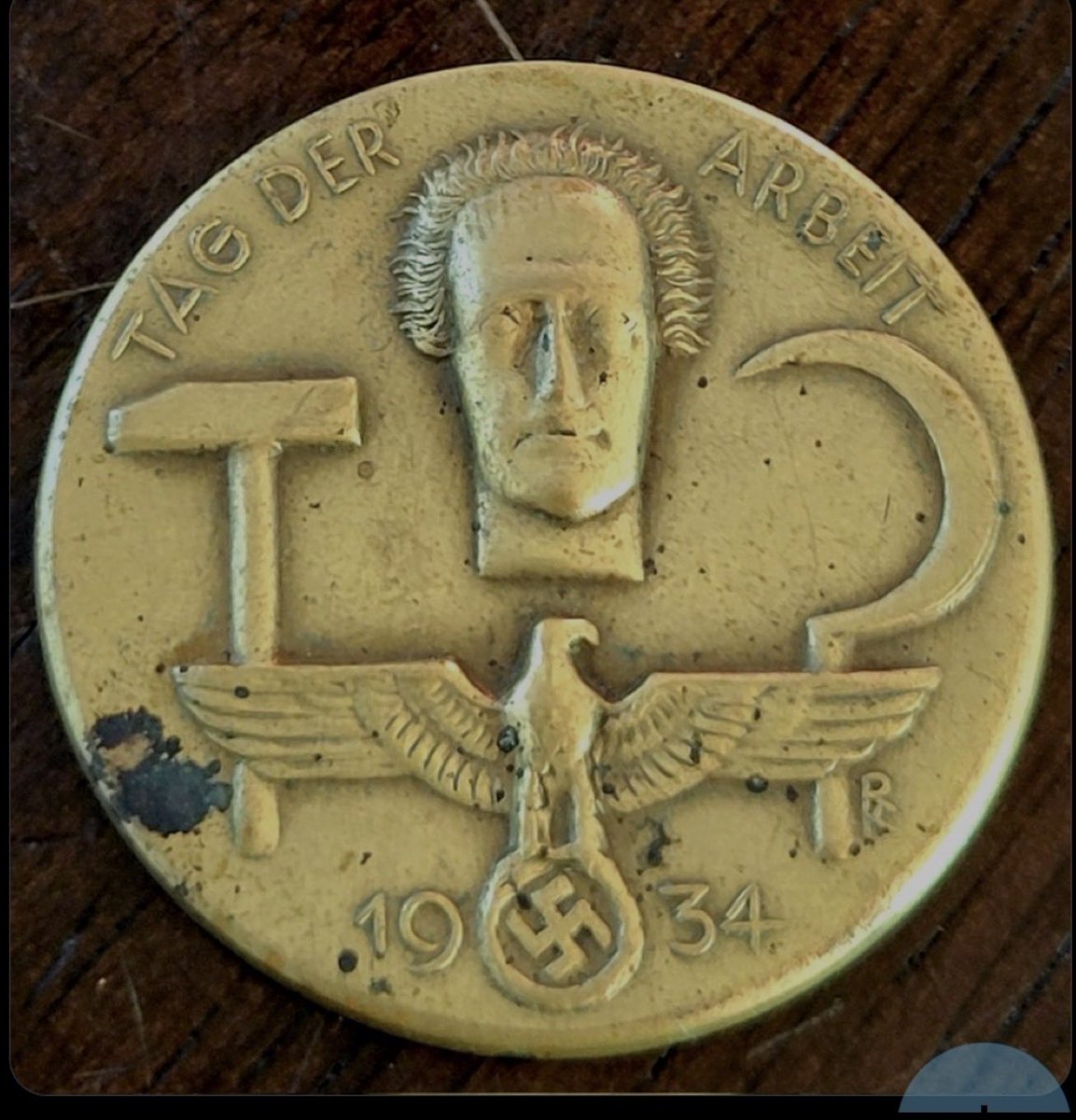 Nazis = National Socialist German Workers Party 

Here (courtesy <a href="/ConceptualJames/">James Lindsay, anti-Communist</a>) is a 1934 Nazi Labor Day medallion.

The Reichsadler, roosted on a swastika, carries a hammer and sickle.