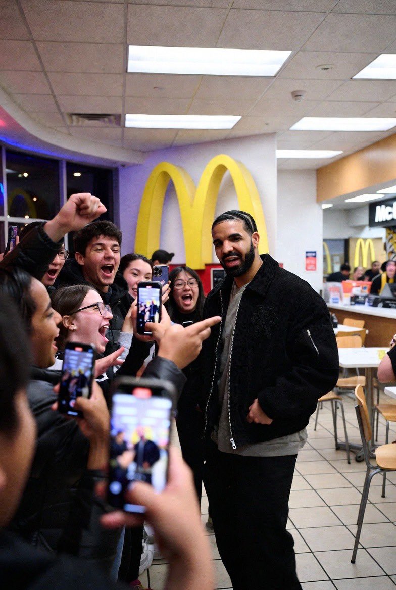 Drake taking photos with fans for his new McDonald’s meal