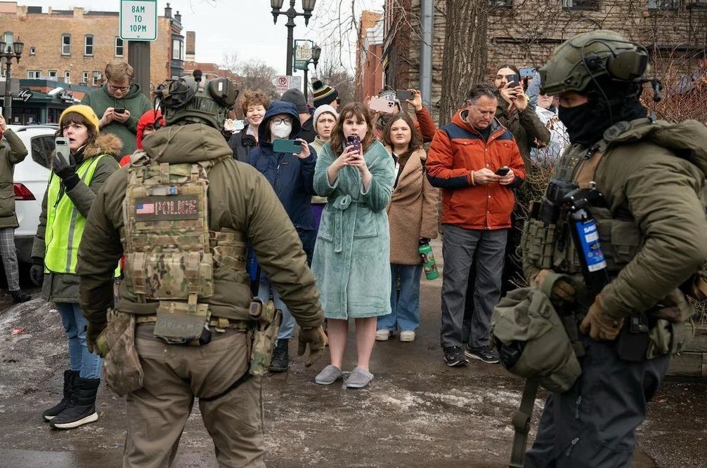 The lady in her bathrobe recording ICE