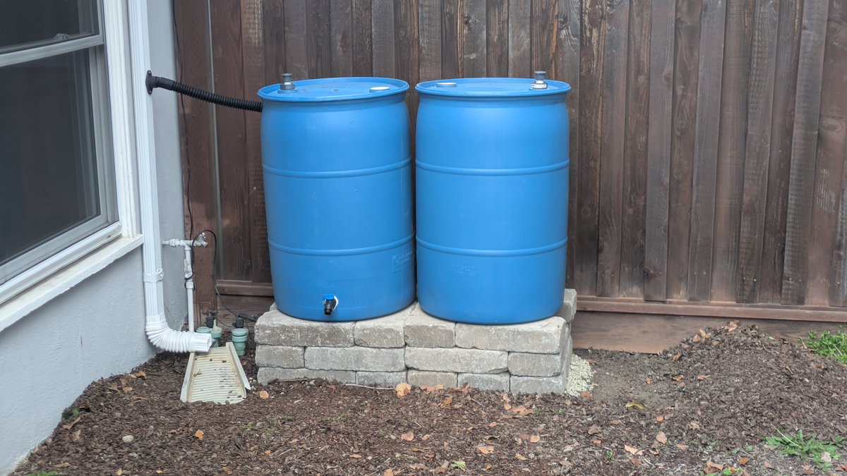 scottstoll's tweet photo. I finished installing my new rain barrels minutes before it began raining. I was questioning if it would be worth it. We don't get much rain. Will it be worth the actual cost and the hidden environmental cost (manufacturing bricks, etc.)? https://t.co/58YTPK63Z0