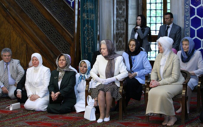 Here is The Queen wearing a scarf while visiting a Mosque in 2010, it's called showing respect.
