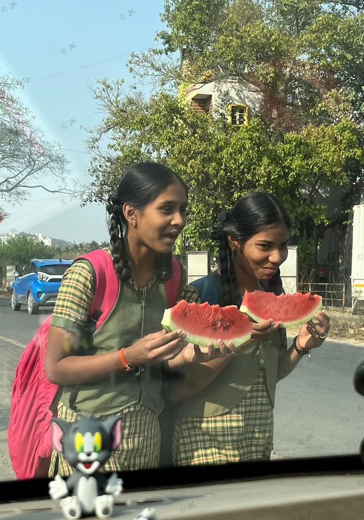 jkeshav's tweet photo. Two school girls enjoying a slice of watermelon in the rural hinterlands! https://t.co/CyskaanmYq