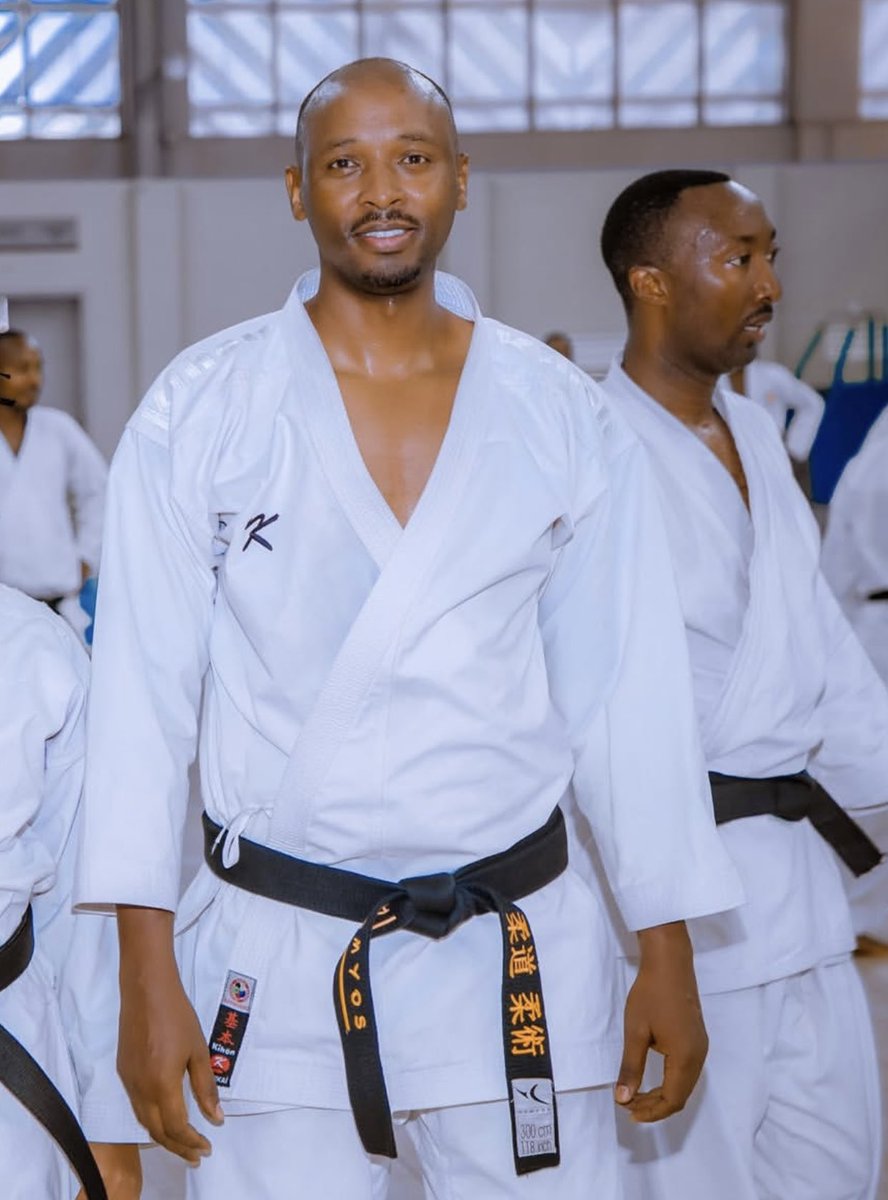 MuhaburaRwanda's tweet photo. The photo captures Minister of Health, Dr. Sabin NSANZIMANA, alongside Commander Khalid KABASHA, both demonstrating their skills in a karate session, proudly wearing black belts. 🇷🇼 https://t.co/MLsZgeVThj