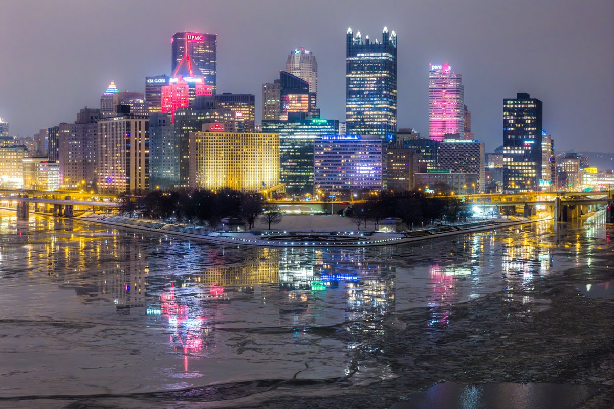 The Pittsburgh skyline reflects on the fractured ice in the three rivers last night. I love how the ice looks like fractured glass! #pittsburgh